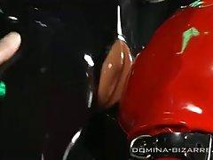 A guy in a red latex licks shaved pussy witch in black latex.